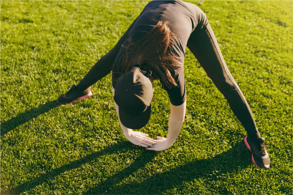Person stretching on grass