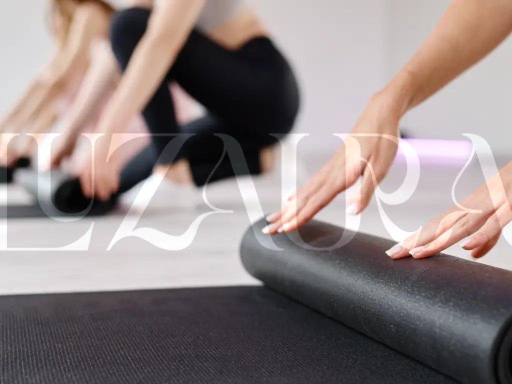Women preparing mats for a mat pilates class.