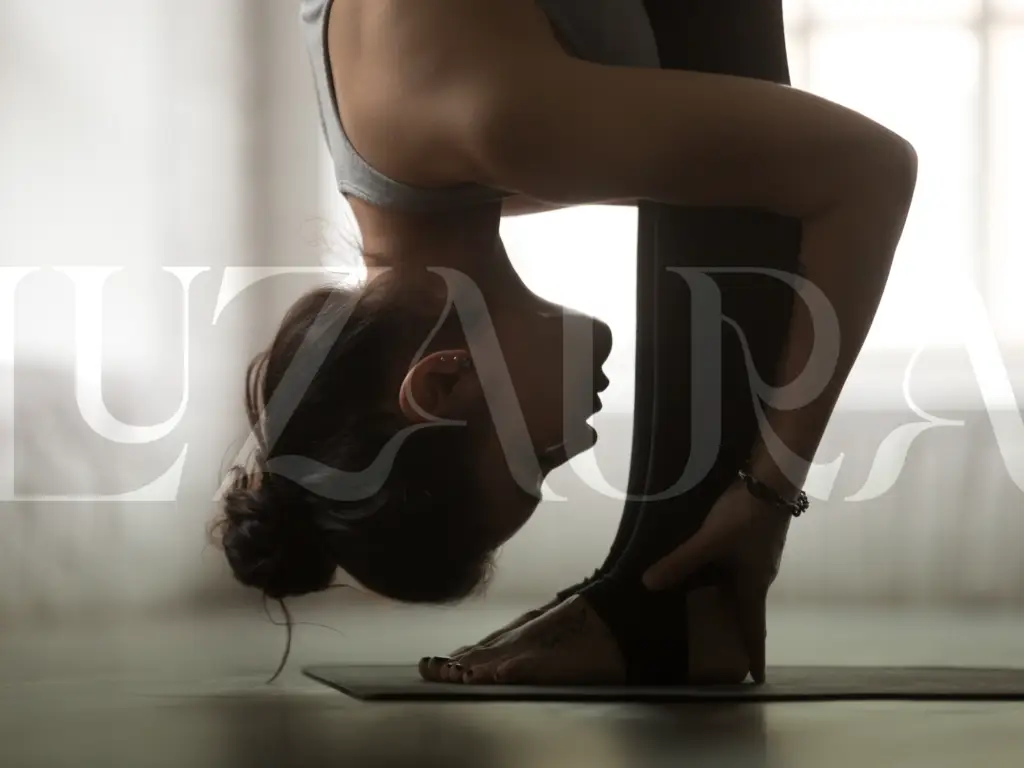 Person in a vinyasa yoga forward-bend pose.