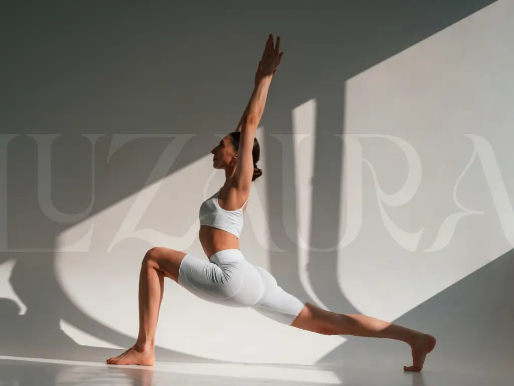 Woman practicing hatha yoga in the Luz Aura studio.